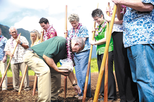 The UH Industrial Hemp Research Project kicked off April 10 with a blessing and planting ceremony in Waimanalo, where principal researcher Harry Ako placed a seed in each prepared hole. Rep. Thielen (behind Ako) long has supported the crop for soil cleaning and bio-fuel uses, and to help farmers stay in business. Photo by Bodie Collins, bcollins@midweek.com.