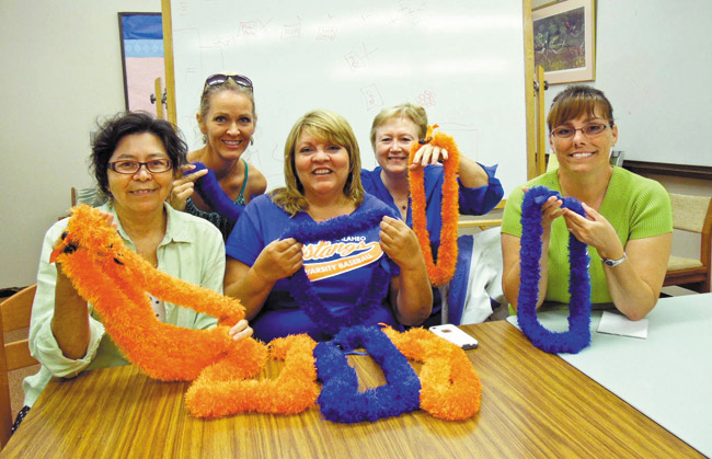 Crafting ribbon lei for the silent auction at Kalaheo High PTSA's May 8 Spring Fling are senior parents (from left) Glee Stormont, Liz Jacobsen, Pam Focht, school PCNC Meg Gammon and Dot Colon. The second annual event supports PTSA scholarships and programs. Photo from Glee Stormont.