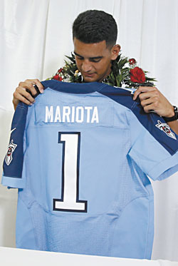 Marcus Mariota checks out his ceremonial jersey as the first-round pick of the Tennessee Titans in the NFL Draft April 30 THOMAS BOYD / THE OREGONIAN / POOL PHOTO