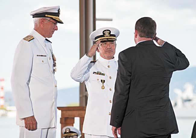 Adm. Harry B. Harris Jr. salutes Defense Secretary Ashton B. Carter as he assumes command of U.S. Pacific Command (USPACOM) during the joint USPACOM and U.S. Pacific Fleet (PACFLT) change of command ceremony at Joint Base Pearl Harbor-Hickam. During the dual ceremony, Adm. Scott H. Swift relieved Harris as the PACFLT commander and Harris assumed command of USPACOM from Adm. Samuel J. Locklear III U.S. NAVY PHOTO BY MASS COMMUNICATION SPECIALIST 2ND CLASS JOHANS CHAVARRO