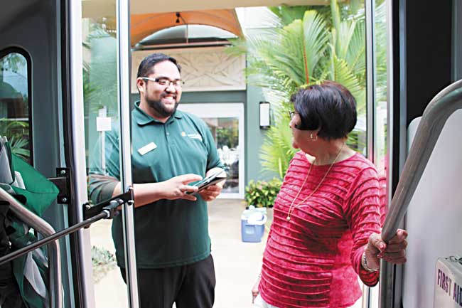 The Plaza at Moanalua activity director Eric Domingo checks in a resident for an outing CHRISTINA O’CONNOR PHOTO