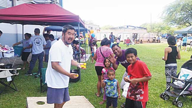 Kokua Compassion Group volunteer Dennis Hida (left) with shelter residents at last year’s Literacy Carnival PHOTO FROM KCG