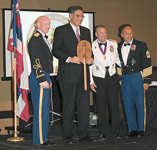 The author receives a paddle of appreciation from (left to right) Lt. Col. Ed Chilton, Col. Bruce Jenkins and SGM Jon Williams PHOTO FROM ALOHA CHAPTER AG CORPS
