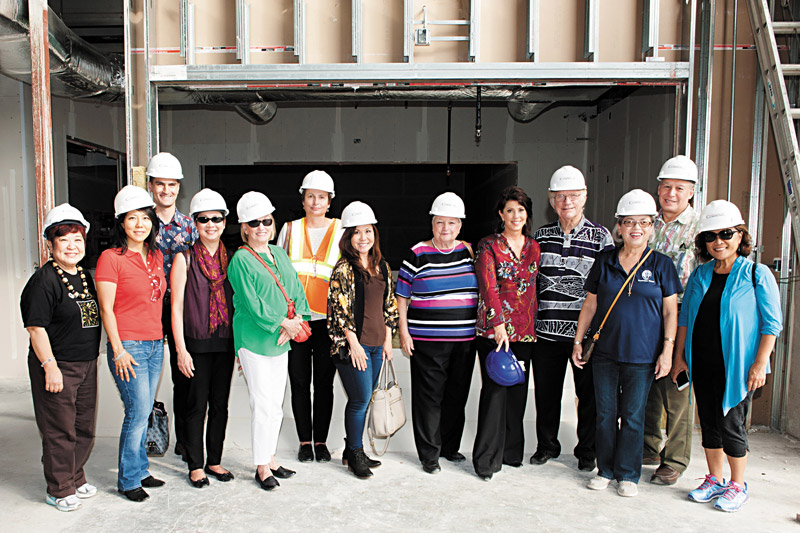 PBS Hawaii president Leslie Wilcox (holding blue hardhat) with the board of directors at the new, under-construction studio