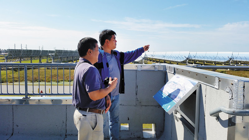 Ryan Kadomoto (left) and Steven Minakami look out at the more than 190,000 solar thermal mirrors that are capable of producing 75 MW of energy at FPL's Martin Next Generation Solar Energy Center in Florida MARI CARDINES PHOTO 