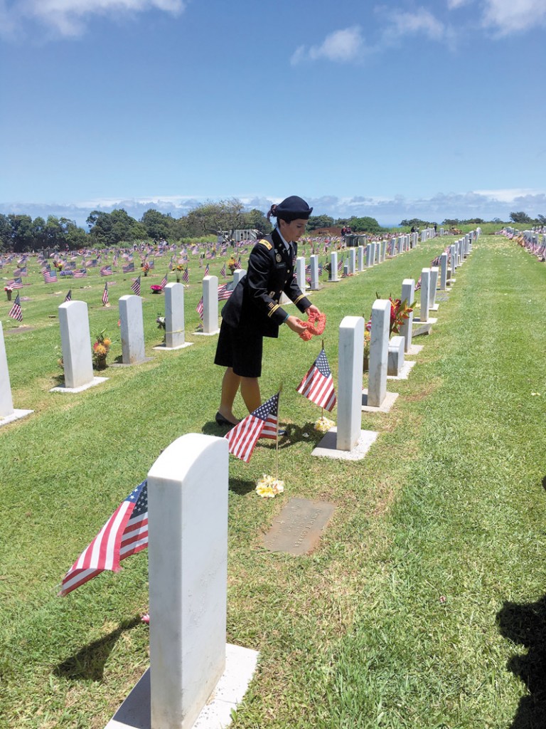 U. S. Rep. Gabbard, a major in the Hawaii Army National Guard, offers lei to fallen heroes at Makawao Veterans Cemetery before delivering keynote remarks at a Memorial Day Ceremony 