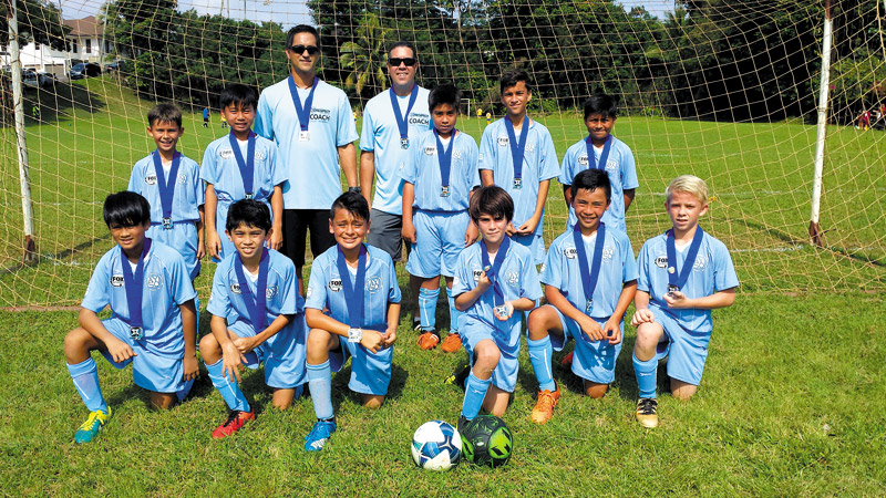 The Wai Kai Warriors of Kailua AYSO U12 Boys team with their championship medals after winning first place in their division at the Islands Best Tournament Dec. 17 and 18 at Waipio Soccer Complex. Pictured are (front, from left) Loren, Evan, Dominic, Torin, Cayden, Zachary, (back) Jackson, Jonathan, coach Alika, coach Kevin, Kekoa, Sean and Miguel. Missing: Josh
