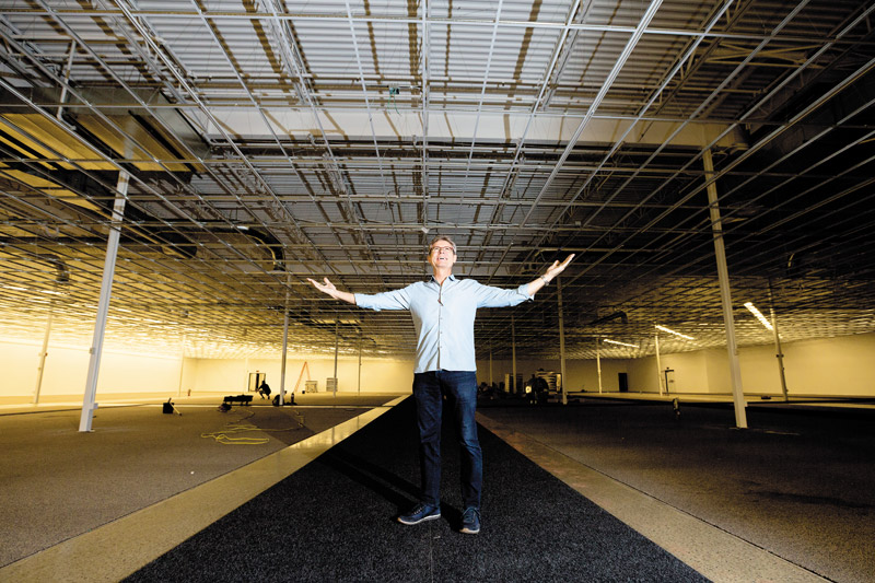 Owner Thomas Sorensen standing in the unfinished showroom at the new INspiration at Kapolei Commons 