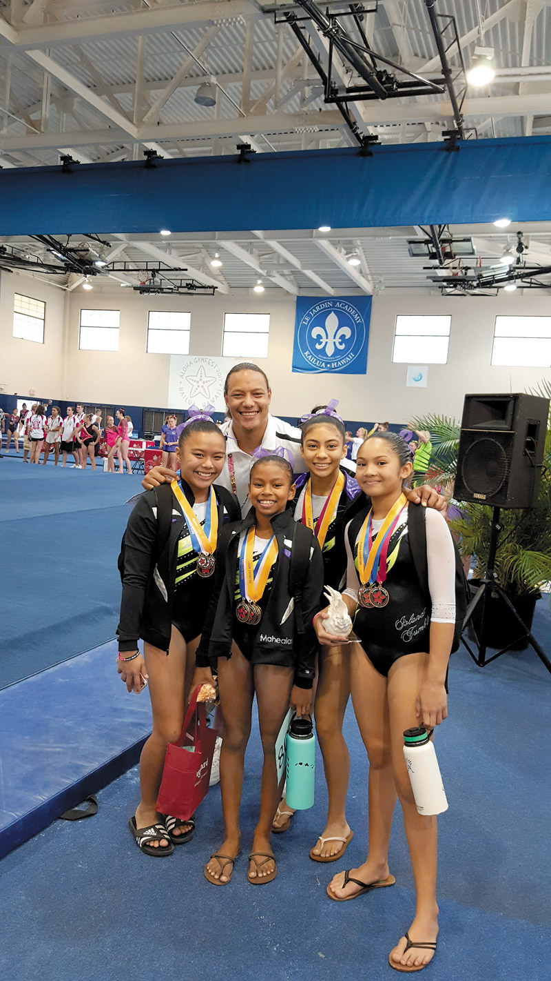 Level 8 gymnasts Jaeden, Mahea, Sarah and Rylee from Island Tumblers Gymnastics with coach David at Aloha Gymfest 