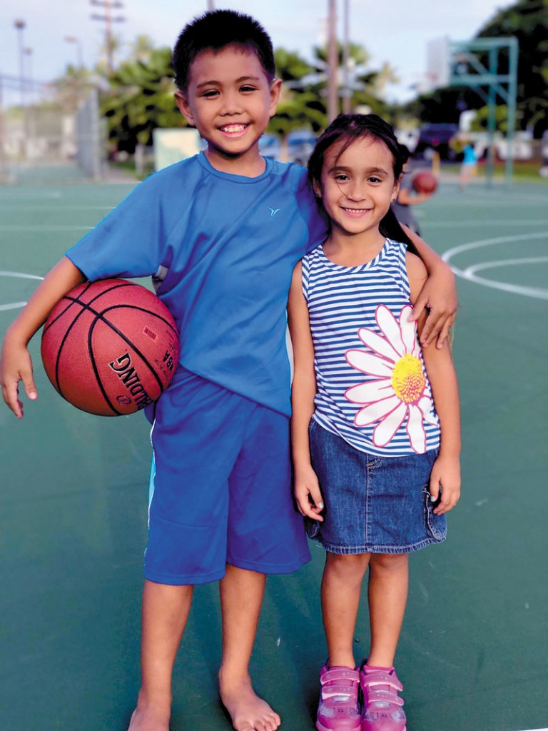 Dezmend Loando and Genesis Lee take a break from basketball practice at Kailua District Park.