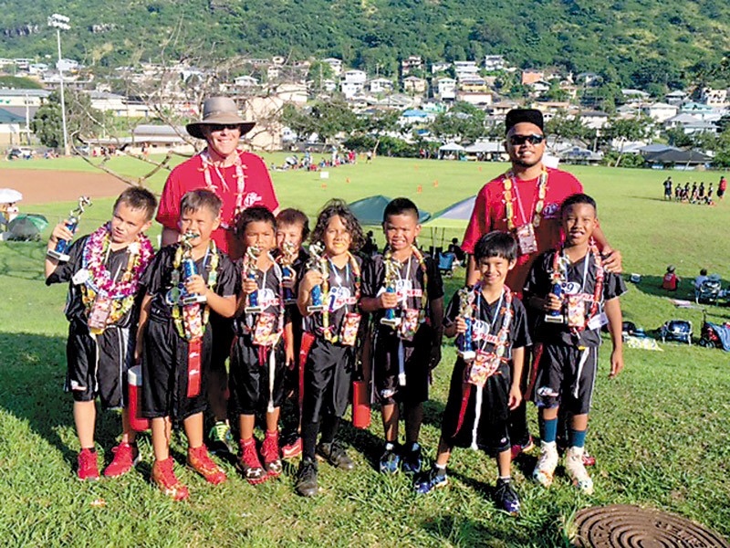 The Silver Sharks from Kapolei celebrate their championship win at Palolo Valley District Park.