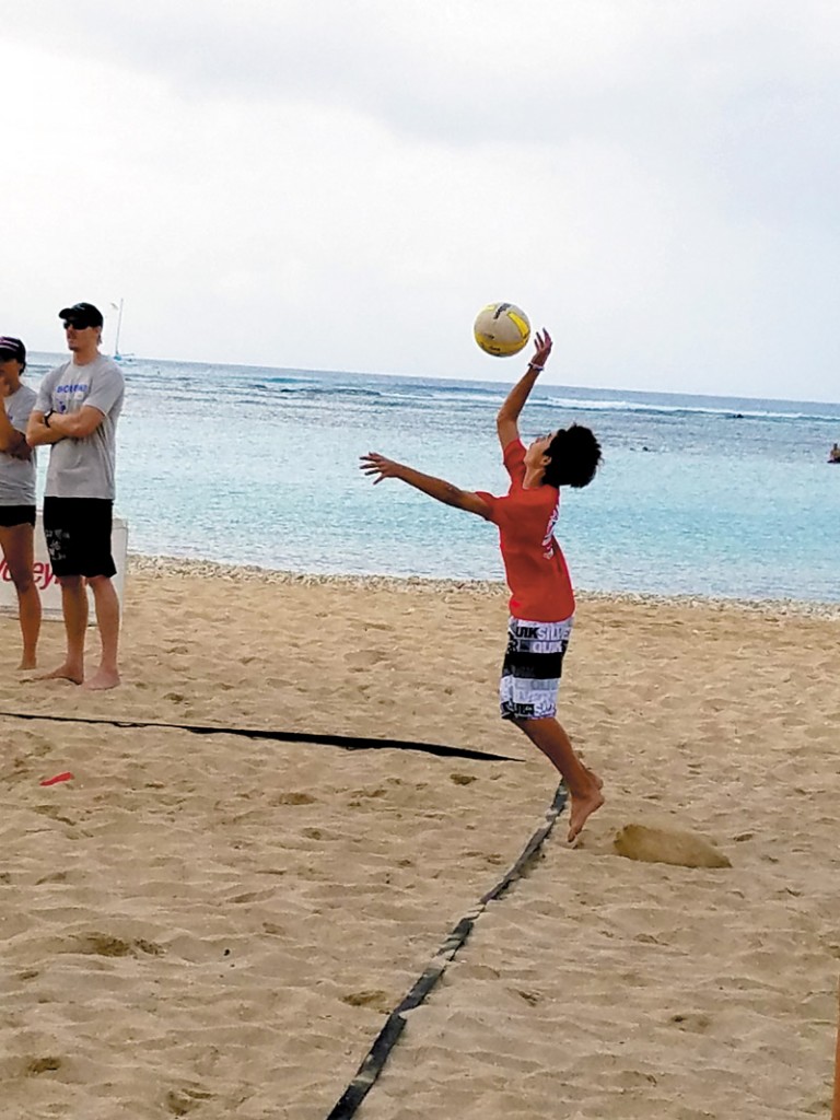 Xander Pink playing beach volleyball.