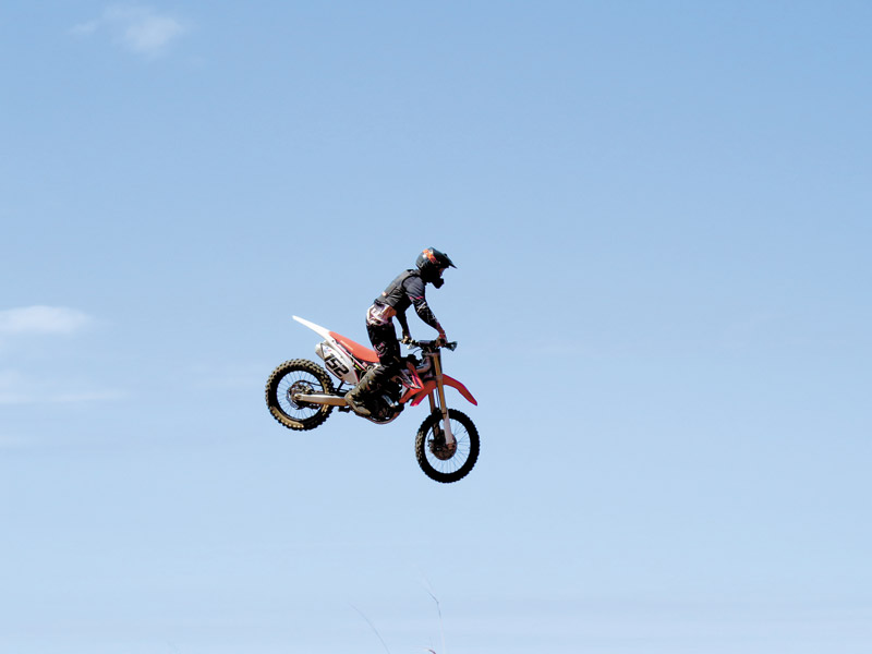 Kahuku High School junior Po‘okela Burtch, who races in the HMA MX 450 expert class, catching air at Kahuku Track